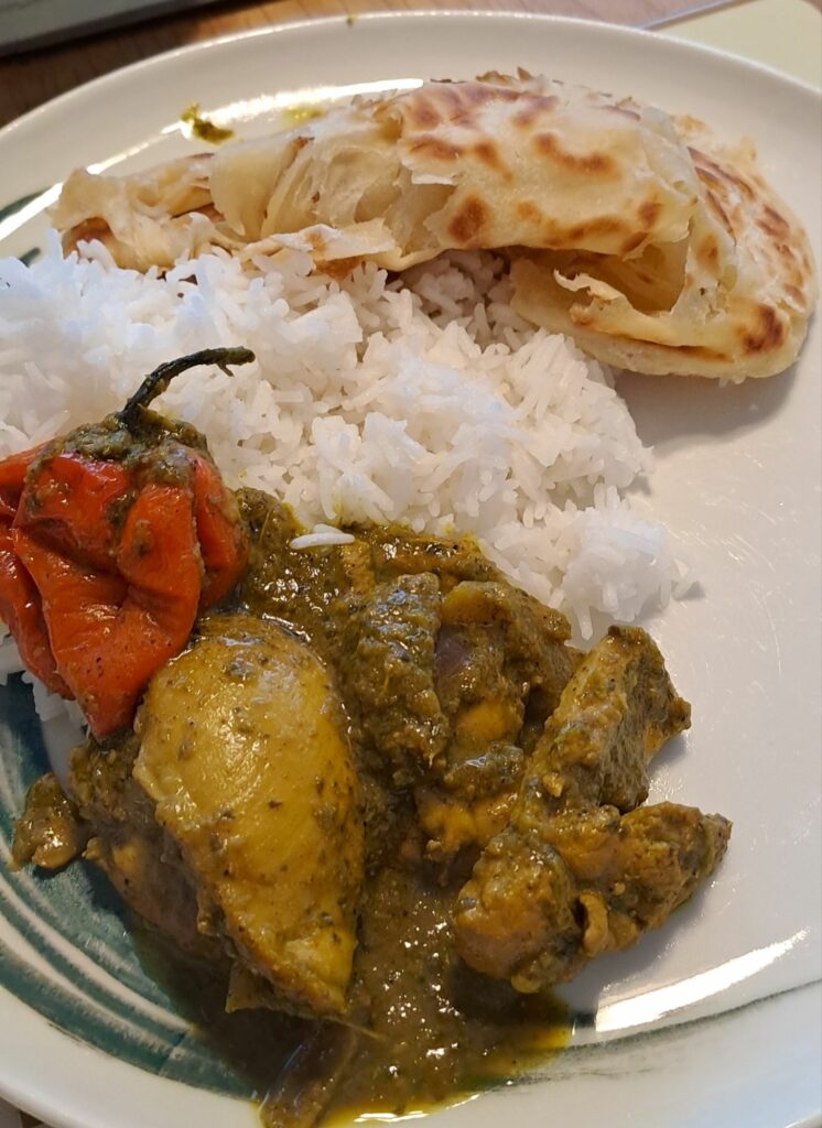 Trini curry chicken with rice and Buss Up Shut