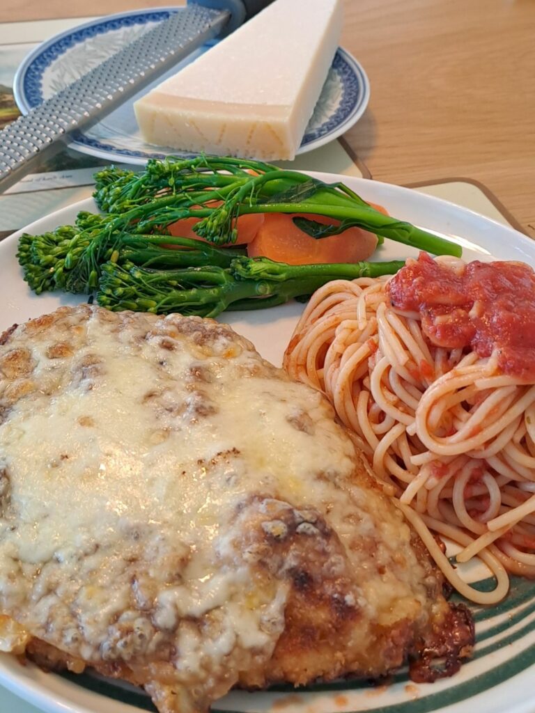 Chicken parm with tomato sauce spaghetti and buttered vegetables