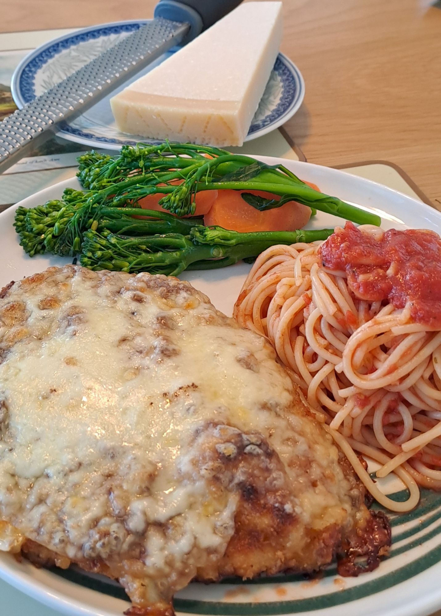 Chicken parm with tomato sauce spaghetti and buttered vegetables